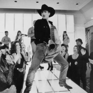 Still of Woody Harrelson and Marg Helgenberger in The Cowboy Way 1994