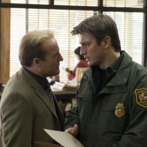 Still of Gregg Henry and Nathan Fillion in Slither (2006)