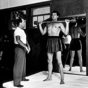 Rock Hudson with his trainer at a studio gym 1952