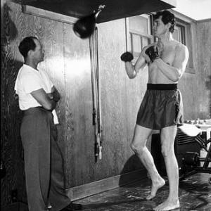 Rock Hudson with his trainer at a studio gym 1952