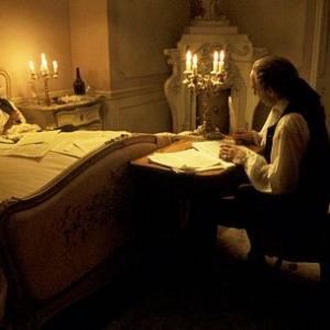 An ailing Mozart (TOM HULCE) dictates notes of music to Salieri (F. MURRAY ABRAHAM) who writes them down for him