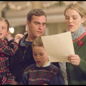 Linda (Jacinda Barrett, right) and Jack Morrison (Joaquin Phoenix, center left) share a tender moment with their children Katie (Brooke Hamlin, left) and Nicky (Spencer Berglund, center right) on Christmas Eve in Baltimore.