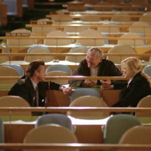 L to r SEAN PENN as federal agent Tobin Keller DirectorExecutive Producer SYDNEY POLLACK and NICOLE KIDMANas UN interpreter Silvia Broome on the floor of the General Assembly during filming of The Interpreter a suspenseful thriller of international intrigue set inside the political corridors of the United Nations and on the streets of New York