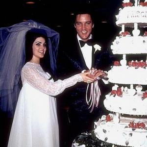 Elvis Presley and his bride, the former Priscilla Ann Beaulieu, cutting their wedding cake in Las Vegas, 5/26/67.