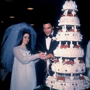 Elvis Presley and his bride the former Priscilla Ann Beaulieu cutting their wedding cake in Las Vegas 52667
