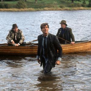 Desmond PIERCE BROSNAN jumps into the water to confront Michael STEPHEN REA and Nick AIDAN QUINN