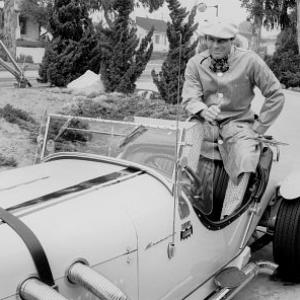 Adam West at home with his Excaliber car, 1966