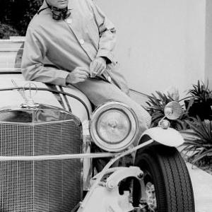 Adam West at home with his Excaliber car, 1966