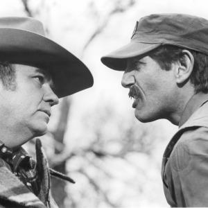 Still of Peter Coyote and Hoyt Axton in Endangered Species (1982)