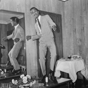 Sammy Davis Jr. tap dances on a table in his hotel room on May 3, 1966.