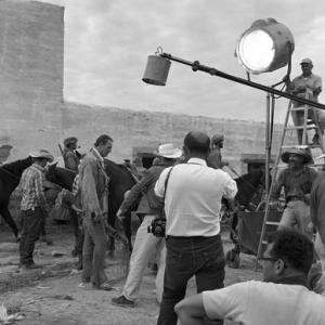 Photographer Bernie Abramson shooting John Wayne on location during the filming of The Alamo