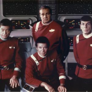Larry A Thompson posing aboard the Starship Enterprise with Star Trek cast