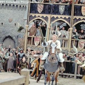 Amid the adrenaline-charged cries of spectators-including (from left to right, background) Kate (Laura Fraser), Chaucer (Paul Bettany) and Roland (Mark Addy), aspiring knight William (Heath Ledger, foreground) rides into fame