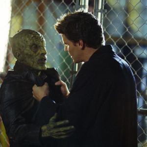 (L-R): Prio Motu (Andy Kreiss) steps from the shadows and attacks Angel (David Boreanaz) who in turn snaps his neck and kills him. From the episode: 