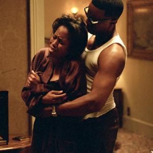 JAMIE FOXX as American legend Ray Charles and REGINA KING as vocalist Margie Hendricks in the musical biographical drama Ray