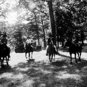 The Beatles Paul McCartney George Harrison John Lennon  Ringo Starr on horseback into the woods in Ozarks Arkansas c 1965