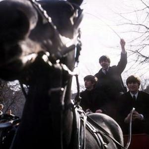 The Beatles ( Ringo Starr, Paul McCartney, John Lennon on a horse carriage ride. Paul is the only one standing)