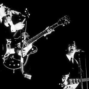 The Beatles (Paul McCartney, George Harrison, & John Lennon) in performance, 1964