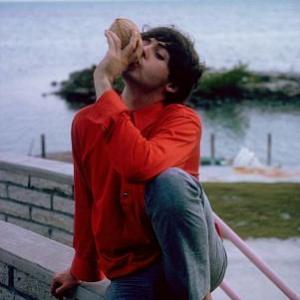The Beatles Paul McCartney jugging the juice out of a coconut 1964