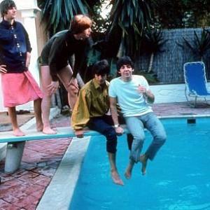 The Beatles ( Ringo Starr, John Lennon, George Harrison, Paul McCartney on the diving board. Geroge and Paul sits and dangles at the edge of the diving board.