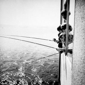 The Beatles (Paul McCartney, John Lennon, George Harrison,& Ringo Starr) fishing out of a window in Seattle, Wa,