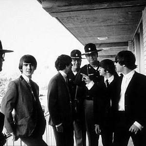 The Beatles George Harrison Paul McCartney Ringo Starr and John Lennon accompanied by officials c 1964