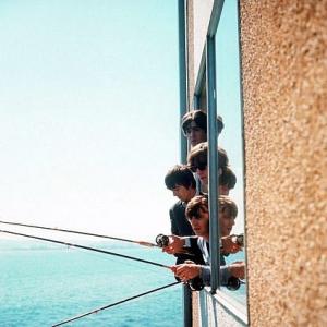 The Beatles ( George Harrison, Paul McCartney, Ringo Starr, John Lennon) fishing through a window, 1964