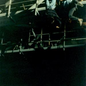 John Ashker (stunt cordinator) takes a high fall while Carl Thibault, (David Mitchell/producer) hangs on for dear life. Also as Donald D'Amico, writer/director looks on (far left corner).