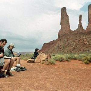 On a whirlwind four-day research trip to some of America's most scenic locations, production designer KATHY ALTIERI (far right) and art directors LUC DESMARCHELIER (left) and RON LUKAS take a moment to sketch the unique rock formations of Monument Valley