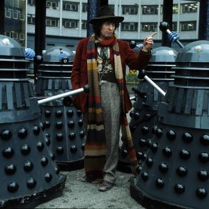 English actor Tom Baker in his role as the fourth incarnation of Doctor Who in the British science fiction television series of the same name. With him are two of his arch-enemies the Daleks in 1975 in London, England.