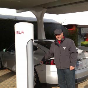 Continuing to make alternative fuel vehicles a personal cause, Dave Bean is shown at a Tesla Supercharger station, where the all-electric Model S is shown recharging. Tesla's Model S is Motor Trend Magazine's 2013 Car of the Year.