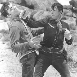 Leon Beaumon gets punched by Ken Maynard in Western Frontier