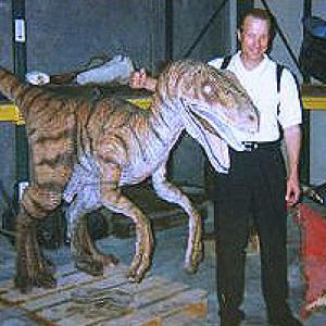 Director Ken Berris poses with one of the animatronic raptors used in Universal's Jurassic Journal, the film he directed in Orlando and Toronto.