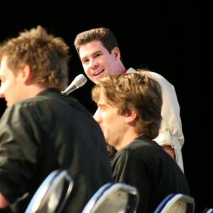 Ralph Garman standing moderates the District 9 panel with director Neill Blomkamp L and lead actor Sharlto Copley