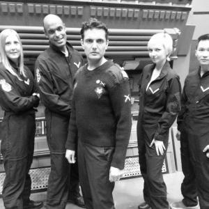 Kam Brar as Captain John Parrish with his crew, in the dramatic short subject science-fiction film GOING HOME.