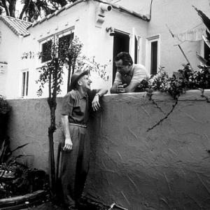 Rossano Brazzi and his neighbor Jimmy Durante in his backyard at home in Beverly Hills CA 1958