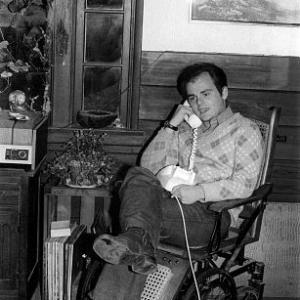 Gary Burghoff at home in an antique wheelchair C 1973
