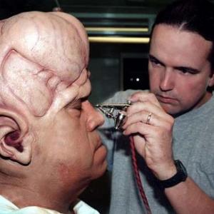 Michael Burnett applies John Schuck's alien make-up for an episode of 