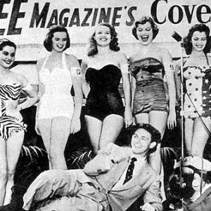 Pin Up Icons JEANNE CARMEN 3rd from left with a striped bikini  BETTIE PAGE 3rd from right with a white onepiece swimsuit are finalists in a NYC beauty contest for SEE Magazines Cover Girl contest Pictured on the ground taking photos are L