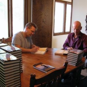 Don Caron and Lyle Hatcher signing Different Drummers books.