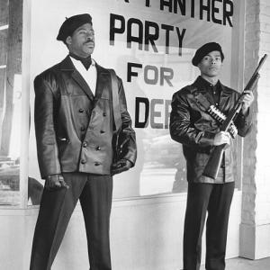 Founding members Bobby Seale (Courtney B. Vance) and Huey Newton (Marcus Chong) keep watch in front of Black Panther headquarters.