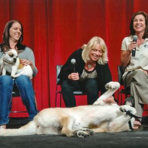 Sarah Clifford (left), holding Brigitte the dog, attending The Academy of Motion Picture Arts & Sciences' 
