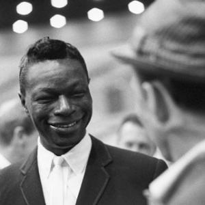 Nat 'King' Cole chatting with Frank Sinatra at an event surrounding the Democratic National Convention
