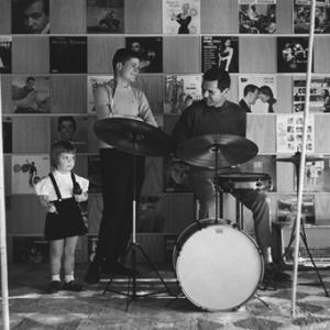 Jackie Cooper playing the drums as daughter Julie and son John Anthony look on
