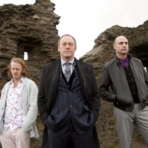 Still of Liam Cunningham Mark Strong and David Wilmot in The Guard 2011