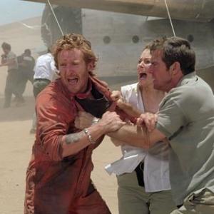 Emotions and tensions run high for passengers of a downed plane lost in the desert including left to right Tony Curran as Rodney Miranda Otto as Kelly and Dennis Quaid as Towns