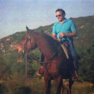 Richard DAlessandro on his Arabian in the hills of CaHe rides western and is pretty good with a rifle and pistol due to his Navel training and his friends he had in the NYPD and LAPD  who often took him to the gun range