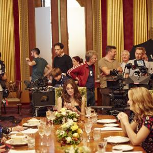 Nick (directly behind camera) on the set of The Royals with Elizabeth Hurley centre