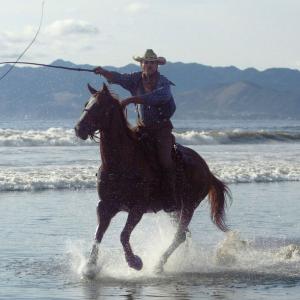 Whipcracking on horseback at Pismo Beach