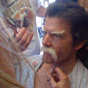Makeup artists apply the prosthetics that will turn Mark Deklin into a 75-year-old man